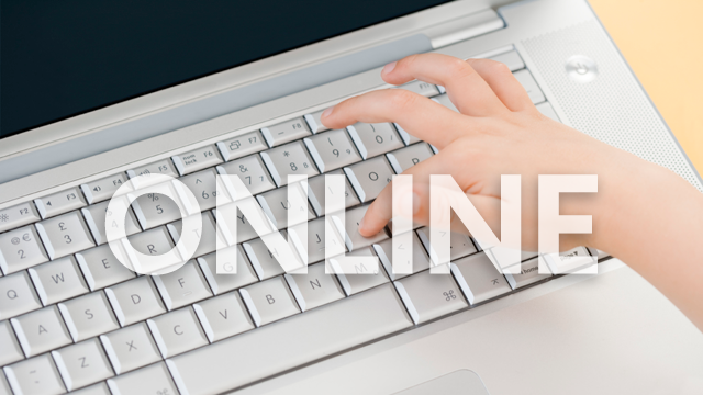 child's hand on a computer keyboard